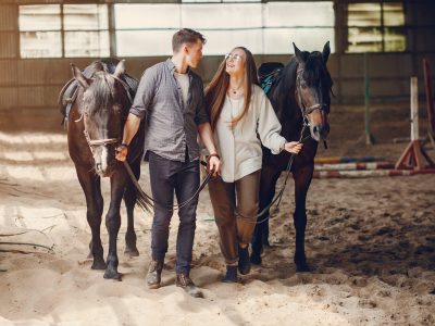 cute loving couple with horse on ranch